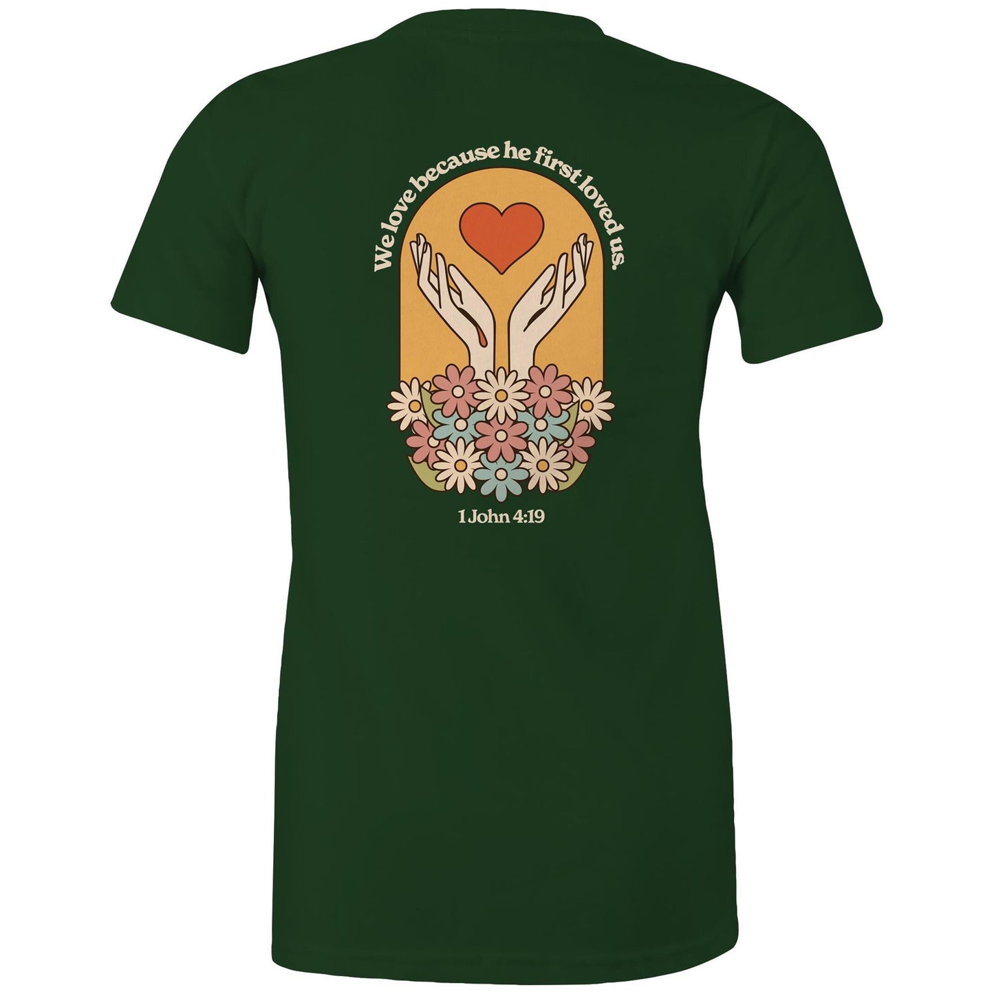 Christian t-shirt with bold faith-based design on the back featuring a red heart, outstretched hands, and colorful flowers. Includes the Bible verse “We love because he first loved us – 1 John 4:19.” Designed by Lighthouse Christian Clothing to inspire love and faith.